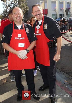 LAPD Officers Steve Sambar and Marco Lozano  ,  at the Los Angeles Mission's Thanksgiving for skid row homeless...