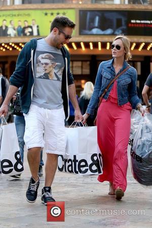 Actor Michael Rosenbaum has his hands full as he leaves Crate & Barrel after shopping at The Grove with his...