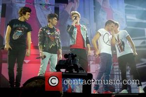 Niall Horan, Harry Styes, Zayn Malik, Liam Payne, Lois Tomlinson and One Direction - One Direction perform at London's O2...