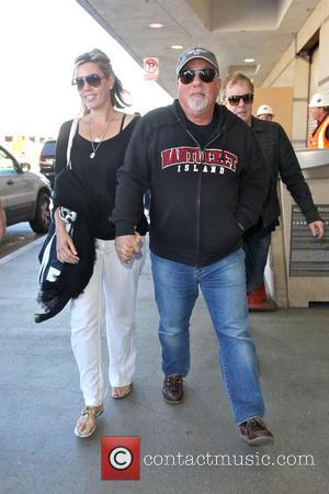 Billy Joel - Billy Joel holds hands with his wife Alexis Roderick, as they arrive at Los Angeles International LAX...