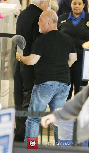 Billy Joel - Billy Joel and his wife Alexis Roderick passes through airport security at Los Angeles International LAX airport...