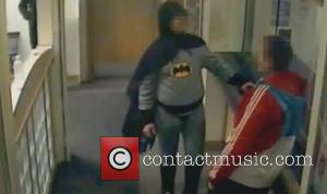 A vigilante dressed as Batman has handed a wanted person into Bradford police. The caped crusader entered Trafalgar House Police...