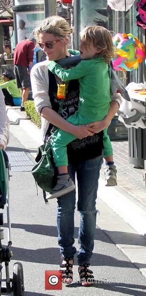 Kathleen Robertson and William Robert Cowles - Canadian actress Kathleen Robertson carries her son as she talks with a friend...