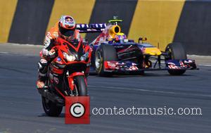 Casey Stoner leads Mark Webber's Red Bull F1 car during the Bike v Car V F1 car showdown - Top...