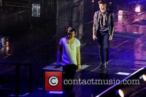 One Direction, Zayn Malik and Harry Styles - One Direction performing in concert at the LG Arena - Birmingham, United...