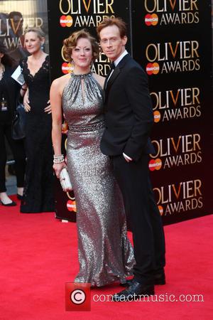 Ed Watson and guest - The Laurence Olivier Awards 2014 held at the Royal Opera House - Arrivals - London,...