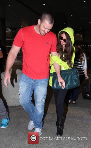Selena Gomez and Brian Teefey - Selena Gomez arrives at LAX Airport on a flight in from Europe accompanied by...