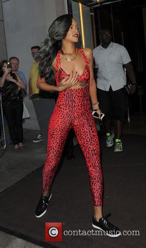 Rihanna - Rihanna leaving her hotel to go shopping, wearing a red Adidas leopard print jumpsuit - London, United Kingdom...