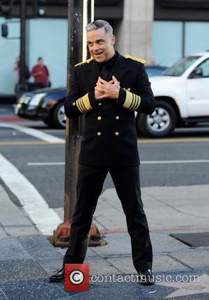 Robbie Williams - UK singer Robbie Williams spotted singing and dancing with a band on the streets of Hollywood Boulevard...