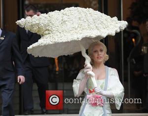 Lady Gaga - Lady Gaga seen leaving her hotel under a shell umbrella. - London, United Kingdom - Thursday 31st...