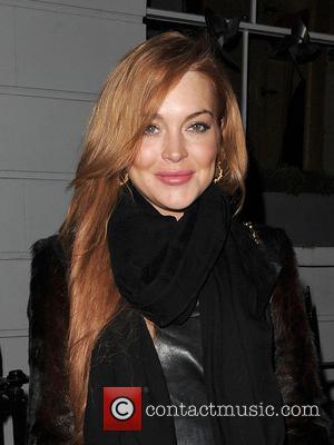 Lindsay Lohan - Lindsay Lohan and a male companion leave...