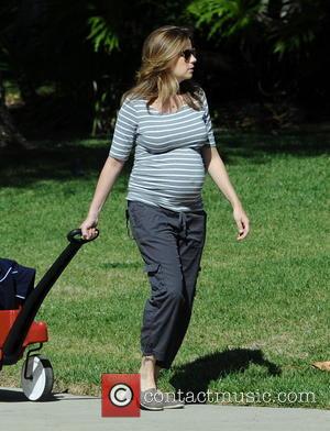 Jenna Fischer - Heavily pregnant Jenna Fischer takes a morning stroll with son Weston, riding in a  Radio Flyer...
