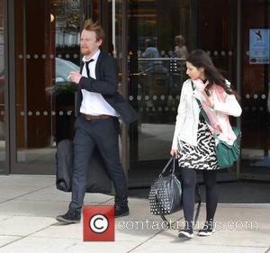 Brian Gleeson & companion - The day after The IFTA awards, actors are seen coming and going from the DoubleTree...