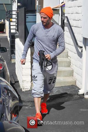 David Beckham - David Beckham leaves SoulCycle gym in Beverly Hills wearing bright orange trainers and SoulCycle - Los Angeles,...