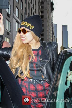Lady Gaga - Lady Gaga dressed in a mini tartan patterned dress and black leather jacket topped by wearing a...