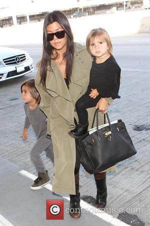 Kourtney Kardashian, Penelope Disick and Jason Mason Disick - Kourtney Kardashian has her hands full carrying daughter Penelope Disick and...