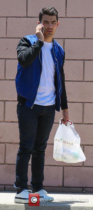 JOE JONAS - Joe Jonas picks up food from Tender Greens to watch the United States men's national soccer team...