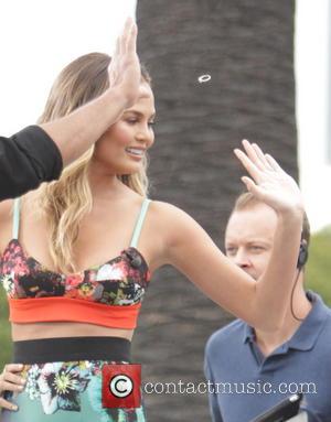 Chrissy Teigen - Chrissy Teigen appears on celebrity entertainment show EXTRA with Mario Lopez at Universal City Walk. While waving...