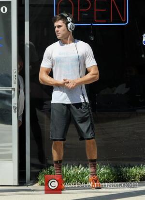 Zac Efron - Zac Efron gets sweaty as he takes a jog around the movie set of 'We Are Your...
