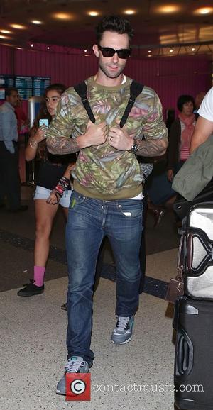 Adam Levine and Maroon 5 - Adam Levine arrives at Los Angeles International Airport (LAX) - Los Angeles, California, United...