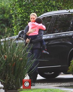 Charlize Theron and Jackson Theron - Charlize Theron dashes out from her black BMW SUV wearing all black with black...