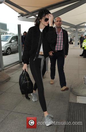 Kendall Jenner - Kendall Jenner arriving at Heathrow Airport. Kendall appeared rather camera-shy, and despite the gloomy weather, wore a...