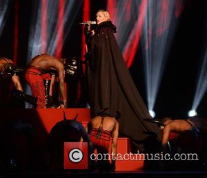 Madonna Falls Off Brits Stage, "My Cape Was Too Tight"