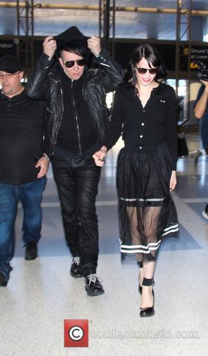 Marilyn Manson and Lindsay Ulrich - Make up free Marilyn Manson arrives at Los Angeles International Airport (LAX) to catch...