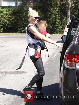 Gwen Stefani - Gwen Stefani has her left ear tugged by youngest son, Apollo, as they walk to church. Her...