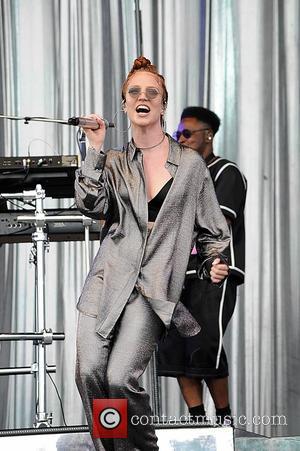 Jess Glynne wearing a silver shirt and matching trousers on the second day of T In The Park 2016. Jess...