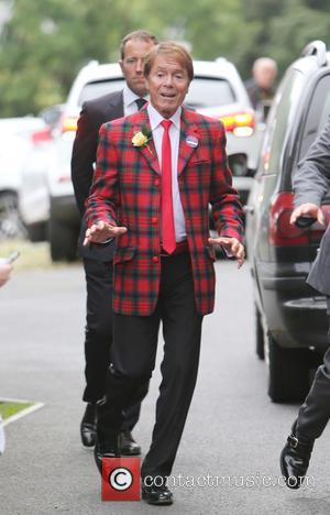 Singer Cliff Richard seen entering The All England Lawn Tennis Club at Wimbledon whist wearing a bright tartan jacket. Cliff...