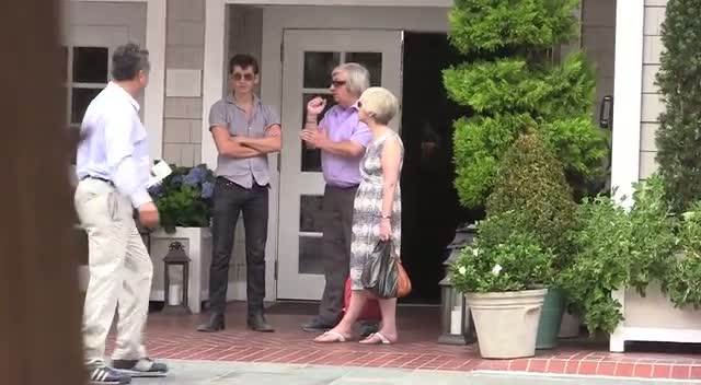 Alex Turner From Arctic Monkeys And His Parents Wait In The Sun To Be Picked Up In A Car